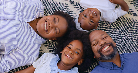 Image showing Portrait, top view and happy family on a floor with love, bond and fun at home together. Face, smile and above kids with parents in a living room with support, security or trust, weekend or african