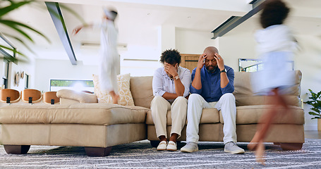 Image showing Children running and parents on sofa with stress, headache or burnout in the living room at home. Upset, mad and African mother and father with migraine for kids playing and having fun in lounge.