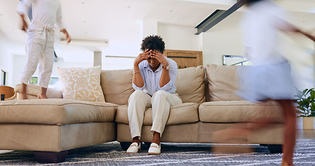 Image showing Children running and mother on sofa with stress, headache or burnout in the living room at home. Upset, mad and young African mom with migraine for kids playing and having fun in lounge at house.