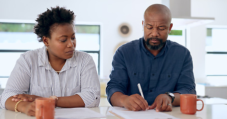 Image showing Couple, married and signature with document in home for paperwork, contract or legal agreement. Black woman, man and worry for future, finances and savings by cover in safety in security for divorce