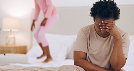 Image showing Frustrated mother, headache and child jumping on bed in stress, anxiety or mental health at home. Tired African mom in depression, mistake or burnout with ADHD kid playing in bedroom chaos at house