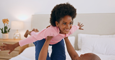 Image showing Bedroom, airplane and happy black family, child and dad playing, having fun and enjoy flying game at home. Bed, love and African papa support, bond or lift kid, girl or daughter imagine plane flight