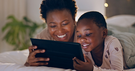 Image showing Mother, child and tablet in bedroom at night watching cartoons in bed with technology and laugh. Happy, enjoying and online for videos, digital and internet in home streaming or bonding together