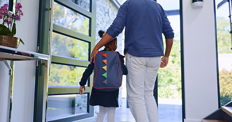 Image showing Father, child and back to school at door, walking in home and leave to start learning. Dad, kid and girl with backpack for first day, education or care, support of student with bag and hands together