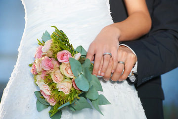 Image showing Couple, wedding ring and hands with bouquet in marriage with bride at celebration and trust event. Flower, loyalty and care with romance and jewelry with love and commitment with woman and man