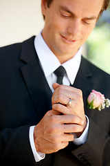 Image showing Groom man, ring and happy for wedding, celebration or commitment to relationship, thinking or pride. Person, metal jewelry and tuxedo suit for marriage, smile and hands at event, party or reception