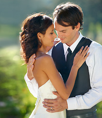 Image showing Outdoor, marriage and bride with groom, hug and support with relationship, romance and celebration. Romantic, outside and man with woman, embrace and happiness with love, bonding together and wedding