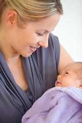 Image showing Closeup, woman and holding of baby in home for love, care or bonding in relationship. Female person, motherhood and looking at child for hope, future or new life for development, milestone or growth