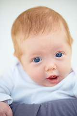 Image showing Closeup, baby and portrait with person in bedroom for childcare, holding or comfort. Infant, hope or new life for love, trust or support of milestone for future, growth or child development with bond