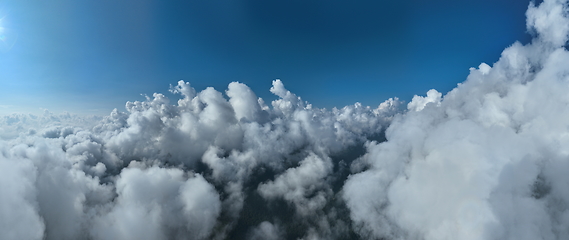 Image showing Drone flight above clouds during a misty sunrise morning