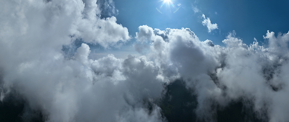 Image showing Drone flight above clouds during a misty sunrise morning