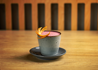 Image showing Strawberry latte with orange peel