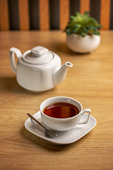 Image showing White tea kettle and white cup