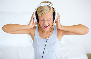 Image showing Home, headphones and woman with streaming music, listening and song with radio, shout and loud. Person, technology or girl with headset, podcast audio and playlist with connection, sound or sing