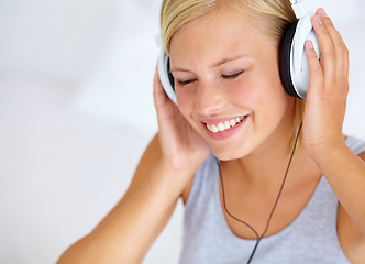 Image showing Home, headphones and woman with music, smile and streaming sound with radio, peace and calm. Zen person, technology or girl with headset, podcast audio and playlist with connection, song or listening