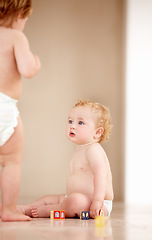 Image showing Baby, siblings and building blocks on a a floor for learning, playing or bonding in a nursery room together. Family, fun and curious children with toys for child development, coordination or color