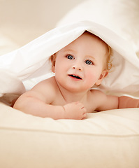 Image showing Happy, face and baby on a bed with blanket for playing, games or fun in a nursery room. Learning, child development and curious boy kid in a bedroom with sheet cover while lying, resting or relax