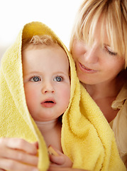 Image showing Bath, towel and baby with mother in a house for love, care and comfort, bond or routine. Family, face and mom with boy child in a bathroom with care, security or hug after cleaning, washing or shower