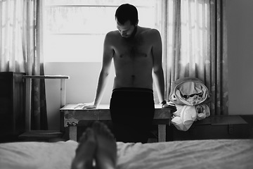 Image showing Man, bedroom and depressed with thinking and cheating with black and white and beard at home. Art, fashion and male person in a house with a problem and anxiety with lonely grief and monochrome