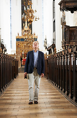 Image showing Walking, aisle and elderly man in a church for sightseeing on a weekend trip, vacation or holiday. Grace, religion and holy senior male person in retirement in a worship cathedral in the city.