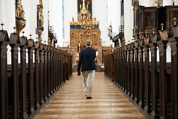 Image showing Walking, aisle and senior man in a church for sightseeing on a weekend trip, vacation or holiday. Faith, religion and back of holy elderly male person in retirement in worship cathedral in the city.