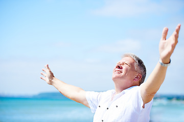 Image showing Beach, freedom and happy senior man with open arms in nature for travel, adventure or celebration. Ocean, smile and elderly male person with retirement vacation at the sea with gratitude in Bali