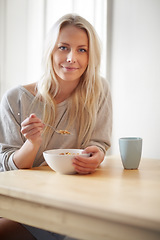 Image showing Portrait, home and woman with breakfast, cereal and start the day with nutrition, coffee and morning. Face, person and girl with a bowl, tea and eating with food, wellness and healthy with a smile