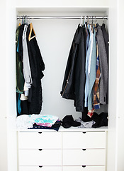 Image showing Wardrobe, clothes and home interior, shelf and fashion in room at house or apartment. Closet, clothing or rack for storage, retail furniture in boutique and store for sale or shopping on a background