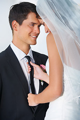 Image showing Love, wedding or romance with a bride and groom in studio on a white background for celebration at a marriage event. Smile, commitment or loyalty with a happy couple getting married as newlyweds