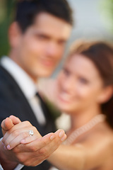 Image showing Hands, ring and a couple on their wedding day for love, romance or celebration at a marriage ceremony. Trust, commitment or promise with a bride and groom together at an event to get married closeup