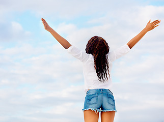 Image showing Woman, back and excited with arms in air with travel, vacation of winner happy from holiday. Winning, African person and blue sky with joy from gratitude, achievement and freedom with break outdoor