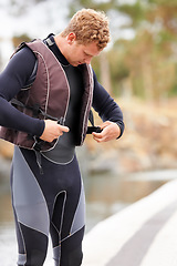 Image showing Man, ready and life jacket at lake, outdoor and extreme sports for fitness, exercise and workout. Person, happy and outdoor by river, nature and float with thinking, health and start summer training