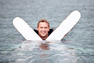 Image showing Man, water ski and portrait in lake, smile and waiting for tow with fitness, extreme sports or exercise. Person, happy and outdoor in river, nature and float with swimming, health and summer training