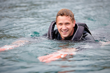 Image showing Man, water ski and portrait in lake, happy and waiting for tow with fitness, extreme sports or exercise. Person, smile and outdoor in river, nature and float with swimming, health and summer training