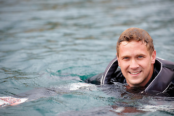 Image showing Man, waterski and portrait in lake, happy and outdoor waiting for tow with fitness, extreme sports or exercise. Person, smile and river in nature, float and swimming for health with summer training