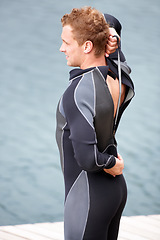 Image showing Man, ready and wetsuit at lake, outdoor and extreme sports for fitness, exercise and workout. Person, swimsuit and thinking by river, nature and safety with ideas, health and start summer training