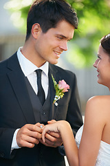 Image showing Bride, groom and wedding ring exchange outdoor with love, care and excited for commitment, union or trust. Smile, happy and couple outside for marriage ceremony with support, security and promise