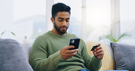 Image showing Man, credit card and phone on living room sofa with online shopping, ecommerce and decision with sale. Person, smartphone and easy payment with click, banking and fintech on lounge couch in home