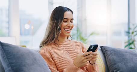 Image showing Woman, living room sofa and texting with phone, smile and click for contact, meme and notification in home. Girl, smartphone and happy with click, reading and app for social media, video and relax