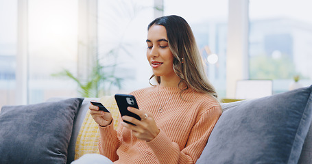 Image showing Credit card, phone and woman on a sofa with ecommerce, sale or bank, loan and payment in her home. Smartphone, app and female person in a living room for online shopping, code or password for sign up