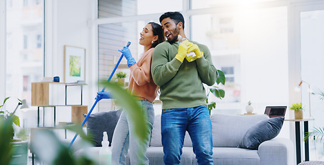 Image showing Happy couple, dancing and singing while cleaning living room together for fun disinfection or hygiene at home. Man and woman enjoying housekeeping, germ and bacteria removal in lounge at house