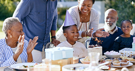 Image showing Black family, birthday party and clapping for a boy child outdoor in the yard for a celebration event. Kids, applause and milestone with a group of people in the garden or backyard together in summer