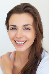 Image showing Portrait, aesthetic and beauty with a young woman in studio on a white background for natural skincare. Face, smile or dermatology and a happy person looking confident with her antiaging skin routine