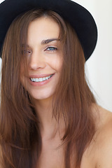 Image showing Portrait, beauty and haircare with a young woman in studio on a white background for natural skincare. Face, aesthetic or wellness and a happy person looking confident in a trendy hat for style