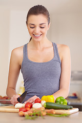 Image showing Woman, thinking and happy with knife or vegetables for nutrition, cooking or healthy meal in kitchen of home. Person, face and chopping board with mushroom, peppers and carrots for wellness and diet