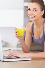 Image showing Portrait, laptop and smile for orange juice with a woman in the kitchen of her home to relax in the morning. Computer, online shopping and a happy young person in the apartment for ecommerce payment