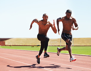 Image showing Man, athlete and running on track for race, practice or training for competition. Black people, together and competitive with dedication, motivation and determination for sport, health and fitness
