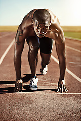 Image showing Portrait, man and ready for race, track and field with practice for competition. Olympics, male runner or athlete with determination on face for sprint, performance or sport by commitment for fitness