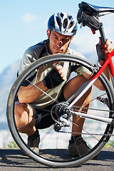 Image showing Check, wheel and man with bicycle on road, street and outdoor exercise with flat tire. Cycling, athlete and closeup on safety, inspection and test for bike with person on asphalt with hand on valve