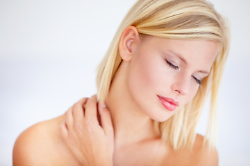 Image showing Woman, skincare and beauty with eyes closed in studio for wellness, care or health by white background. Girl, model and peace with touch for skin, cosmetic change and transformation with natural glow